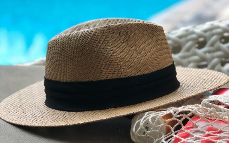 hat and bag next to pool