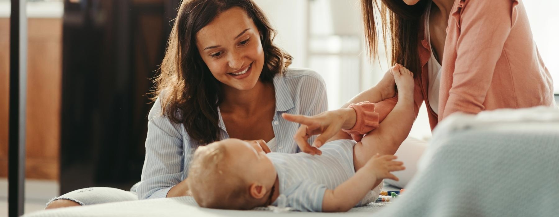 women play with baby