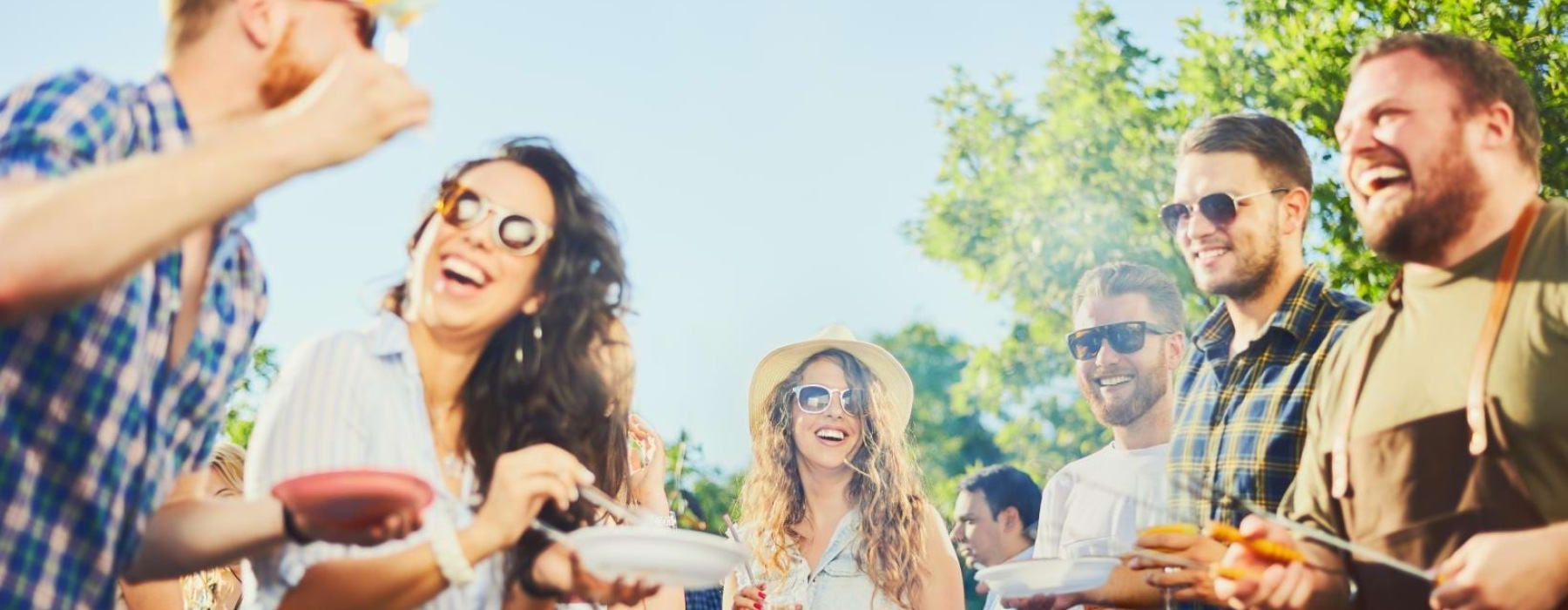 a group of people having bbq in park