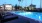 lounge chairs next to swimming pool